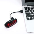 D.Light CG-420R1 in black color USB rechargeable bicycle rear light in charging via a laptop
