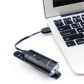 D.Light CG-128P in black color with ambient light sensing aluminum alloy body bicycle headlight in charging via a laptop